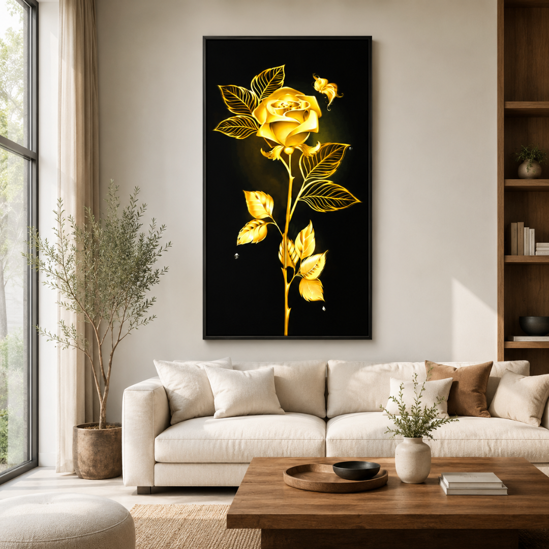 A vertical black canvas wall art print featuring a glowing golden rose and leaves, displayed above a white sofa in a modern, sunlit living room.