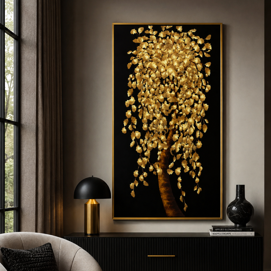 A large vertical framed wall art piece featuring a black background with a tree made of shimmering gold leaves and branches, displayed in a modern living room above a dark console table.