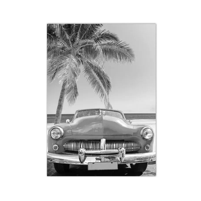 A black and white photographic print or poster showing a vintage car parked outdoors under a palm tree near the beach, centered on a light gray background.