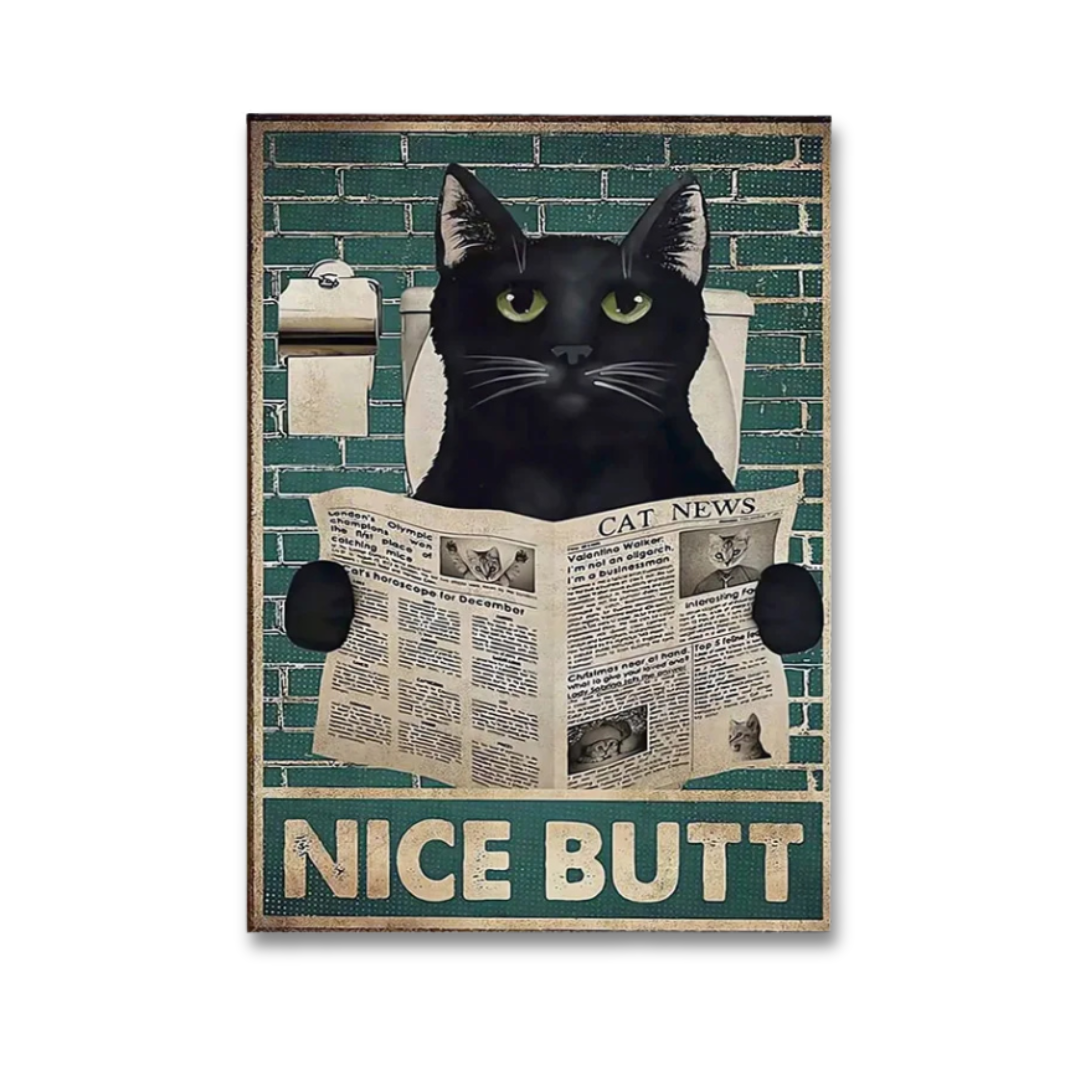 A rectangular novelty print or sign featuring a black cat with green eyes sitting in a toilet and reading a newspaper, with the words 'NICE BUTT' at the bottom. The artwork is centered on a light gray background.