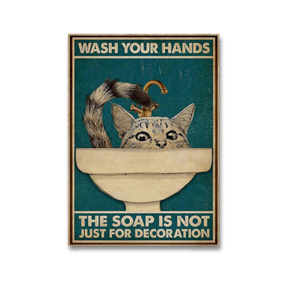 A rectangular vintage-style handwashing poster featuring a cat peeking out of a sink with a faucet. The poster has a dark teal background with cream text reading 'WASH YOUR HANDS' at the top and 'THE SOAP IS NOT JUST FOR DECORATION' at the bottom.