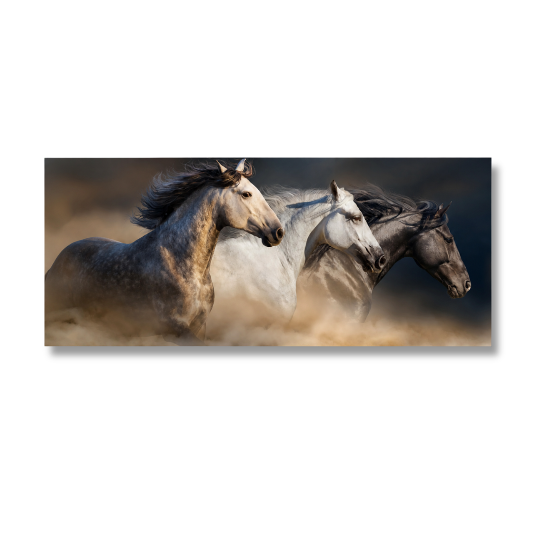 A rectangular wall art print showing three galloping horses in motion against a smoky, dark background, displayed on a clean white wall.