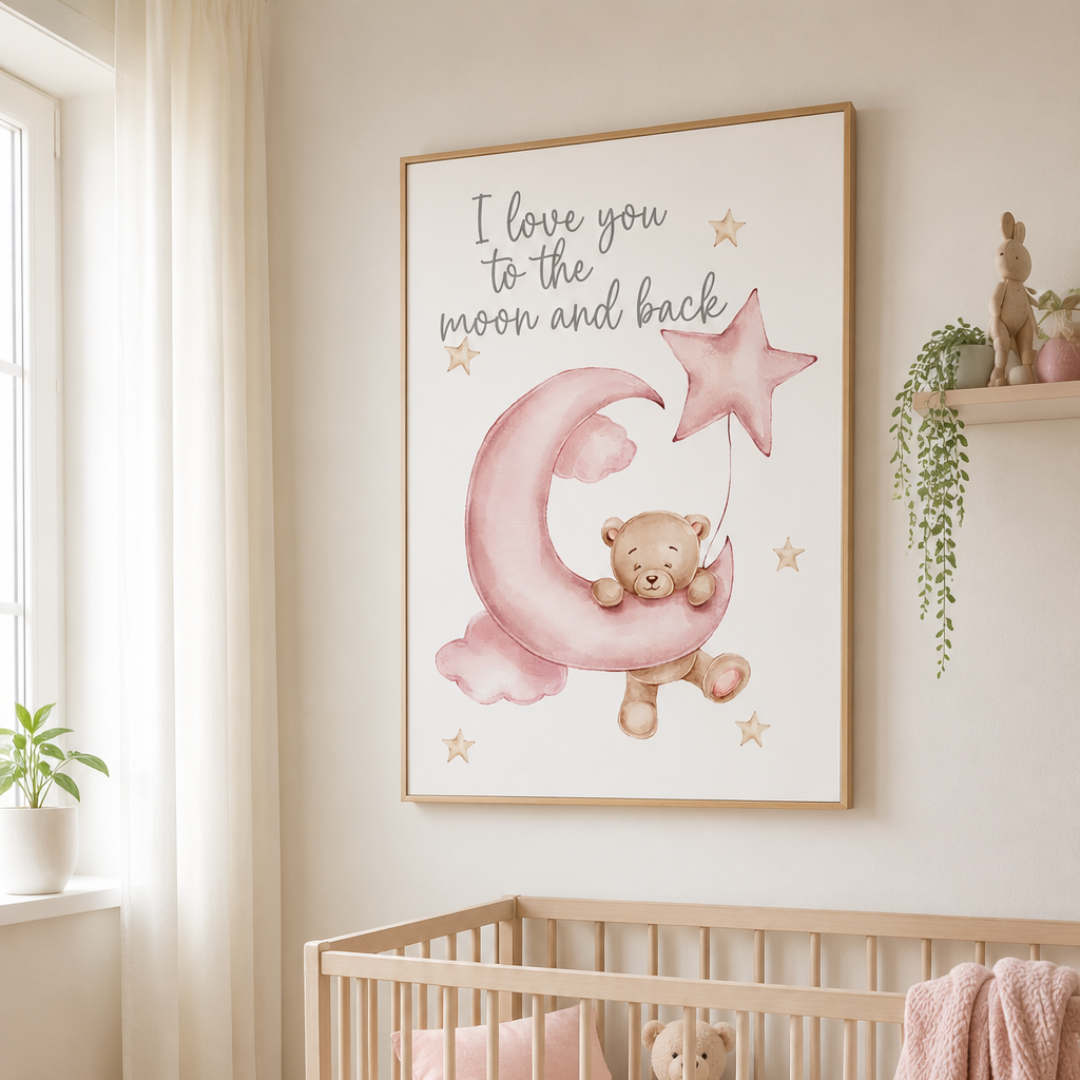 A framed nursery wall art print hanging above a crib in a softly lit baby room. The print shows a teddy bear sitting on a pink crescent moon and holding a pink star, with the text 'I love you to the moon and back' above.
