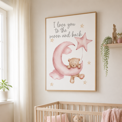 A framed nursery wall art print hanging above a crib in a softly lit baby room. The print shows a teddy bear sitting on a pink crescent moon and holding a pink star, with the text 'I love you to the moon and back' above.
