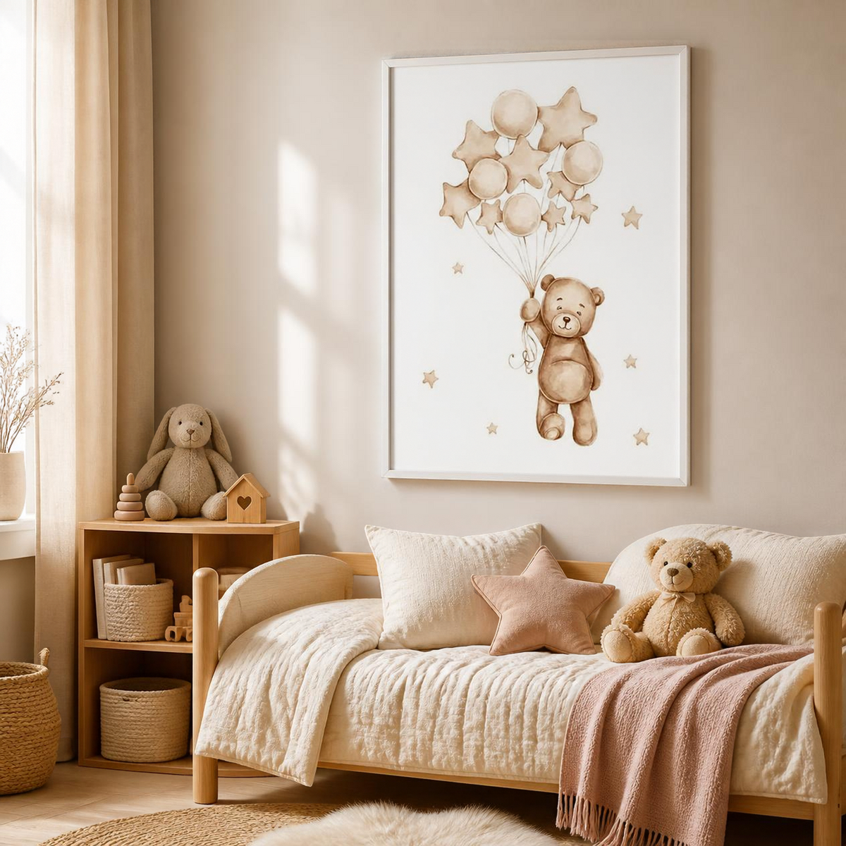 A framed wall art print featuring a teddy bear holding star and oval balloons, displayed above a cream-colored daybed in a softly styled children's bedroom.