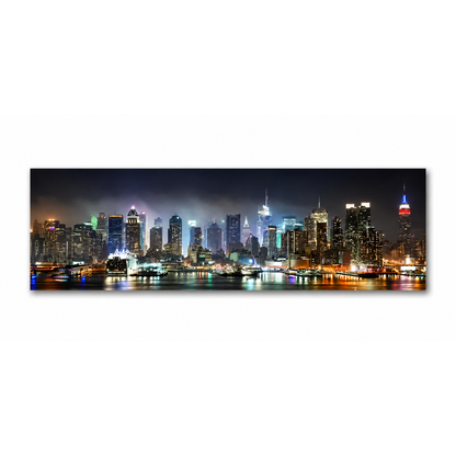 A panoramic canvas print of the New York City skyline at night, featuring illuminated skyscrapers and reflections on the water, displayed against a solid white background.
