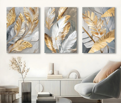 Three abstract wall art panels with gold and silver leaves in a living room setting.