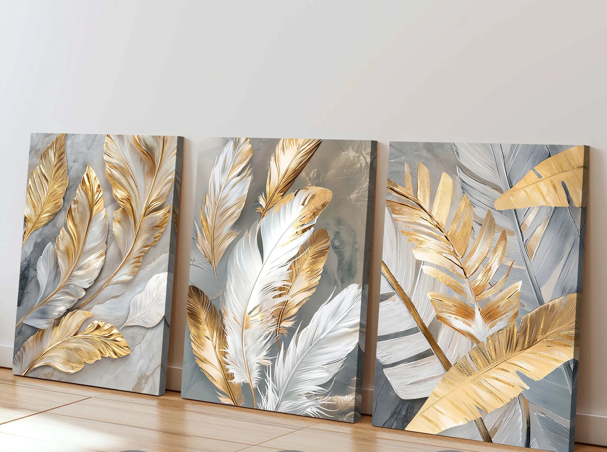 Set of three wall art pieces with gold and silver leaf designs on a neutral background.