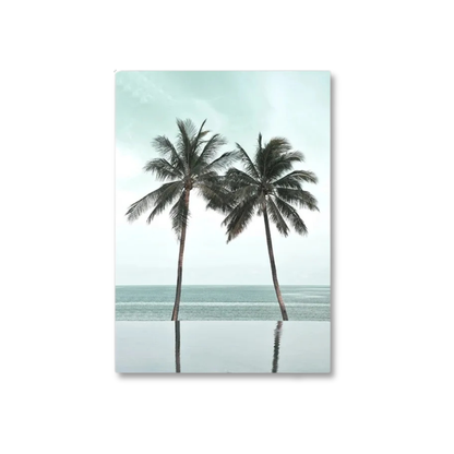 A vertical canvas wall art print featuring two palm trees by an infinity pool overlooking a calm sea under a pale sky, shown against a plain white background.