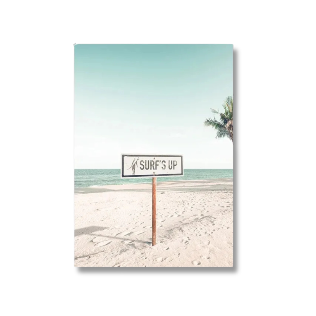 A vertical canvas wall art print featuring a retro beach scene with a sign that reads 'SURF'S UP' on a wooden post, set against a clean white background.